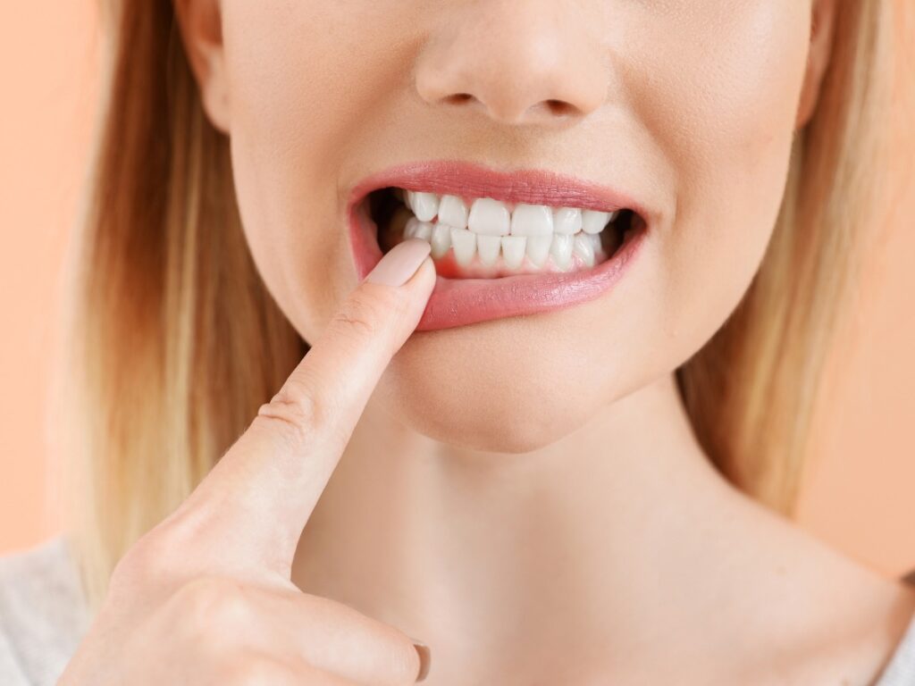 Beautiful woman with healthy teeth on color background, closeup